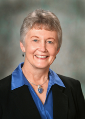 Former Dean Rothert smiling in a suit